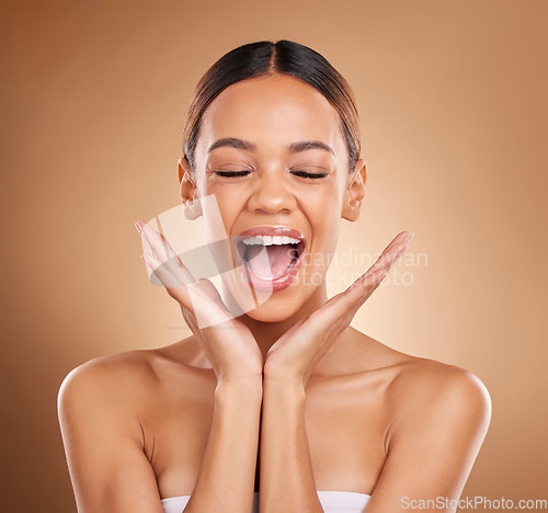 Image of Beauty, excited and a woman with hands on face for skin care glow and shine in studio on brown background. Aesthetic female model with eyes closed for spa facial, dermatology cosmetic and wellness