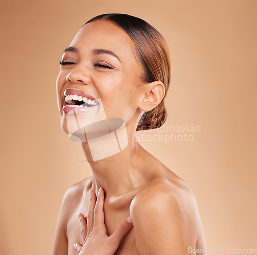 Image of Happy, beauty and a woman laughing for skin glow and shine in studio on a brown background. Face of aesthetic female model satisfied with spa facial, dermatology cosmetics and wellness with skincare