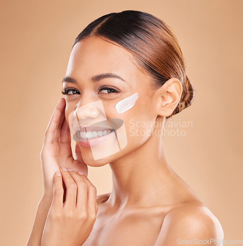 Image of Face, skincare portrait and woman with cream in studio isolated on a brown background. Dermatology, beauty cosmetics and happy female model with lotion, creme or facial moisturizer for skin health.