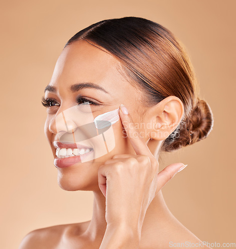 Image of Face smile, skincare and woman with cream in studio isolated on a brown background. Thinking, beauty .cosmetics or happy female model apply lotion, creme or facial moisturizer product for skin health