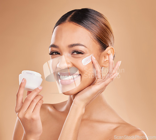 Image of Skincare, face and woman with cream container in studio isolated on a brown background. Dermatology portrait, cosmetics or happy female model apply lotion, creme or moisturizer product of skin health