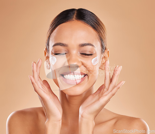 Image of Face smile, skincare and woman with cream in studio isolated on a brown background. Dermatology, beauty cosmetics and happy female model with lotion, creme or moisturizer product for skin health.