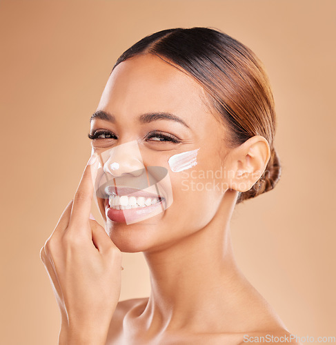 Image of Skincare portrait, face and woman with cream in studio isolated on a brown background. Dermatology, beauty cosmetics and happy female model with lotion, creme or facial moisturizer for skin health.