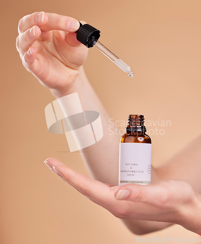 Image of Hands, serum bottle and pipette for skincare in studio isolated on a brown background. Dermatology product, cosmetics and woman or model with hyaluronic acid, retinol or essential oil for anti aging.