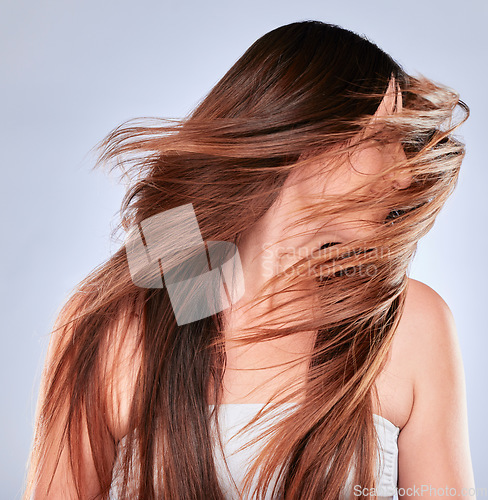 Image of Hair flip, model and happiness of woman with natural beauty, wellness and soft hairstyle texture. Cosmetics, shampoo treatment and keratin of a female with healthy and haircare shine in studio