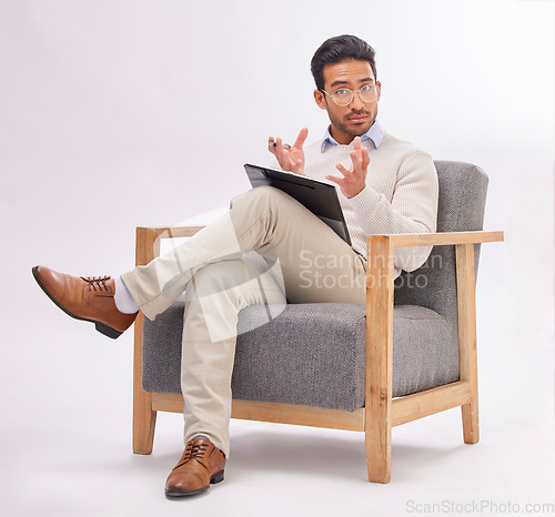 Image of Psychology, psychologist and portrait of man on chair with clipboard in studio isolated on a white background. Therapist, consultant and male with checklist for therapy, mental health and counselling