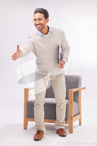 Image of Handshake offer of professional man isolated on a white background, welcome meeting or psychologist client hello. Asian person or therapist shake hands in deal or introduction with armchair in studio