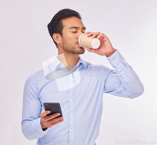 Image of Phone, drinking coffee and business man in studio isolated on a white background. Cellphone, tea break and male professional with smartphone for social media, web browsing or typing on mobile app.