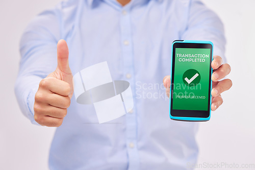 Image of Man, hands and phone with thumbs up for transaction approval against a white studio background. Hand of male showing thumb emoji, yes sign or like for electronic purchase or ecommerce on smartphone