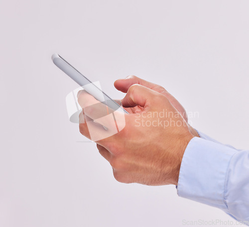 Image of Hands, technology and typing with phone in studio isolated on a white background. Cellphone, networking and male or man with mobile smartphone for texting, social media or internet browsing online