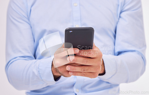 Image of Business man, hands and typing with phone in studio isolated on a white background. Cellphone, networking and male professional with smartphone for texting, social media or internet browsing online.