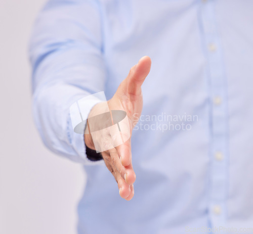 Image of Opportunity, welcome and business man with a handshake in studio for recruitment, onboarding or hiring. Partnership, collaboration and male professional shaking hands for contract, agreement and deal