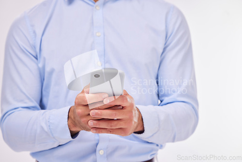 Image of Hands, business man and typing with phone in studio isolated on a white background. Cellphone, networking and male professional with smartphone for texting, social media or internet browsing online