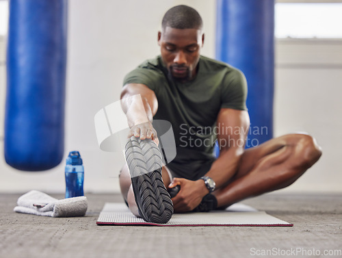 Image of Black man, stretching legs and fitness in gym for training, performance and bodybuilding. Bodybuilder warm up for strong feet, sports workout and start healthy exercise for mobility, energy and power