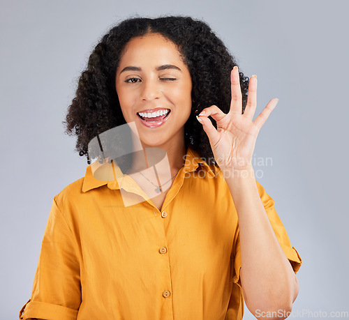 Image of Perfect, happy and portrait of a winking woman isolated on a white background in a studio. Smile, review and girl with a hand gesture for satisfaction, happiness and okay emoji icon on a backdrop