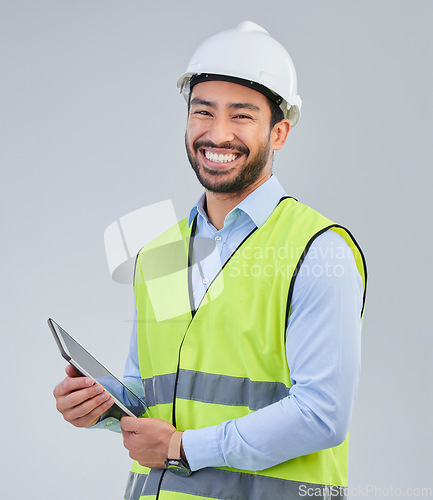Image of Construction worker, portrait and happy man in studio with tablet and helmet safety on white background. Smile, internet and contractor or architect in online planning for project management in India