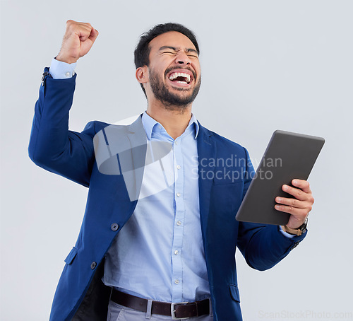 Image of Winner, excited and tablet with man in studio for good news, success and bonus. Pride, yes and celebration with male and cheering isolated on gray background for achievement, pride and job promotion