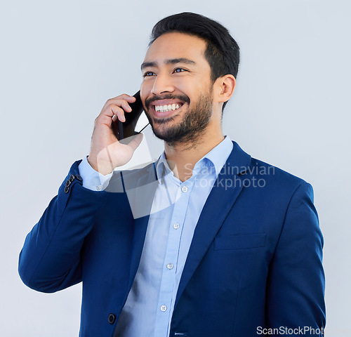 Image of Smile, smartphone and Indian man in studio, talking and networking on white background. Phone call, conversation and businessman in suit, communication and technology for investor trading at startup.