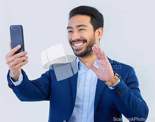 Image of Smartphone, video call and asian businessman in studio with wave, talking and networking on white background. Phone, conversation and b2b communication and technology for investor trading at startup.