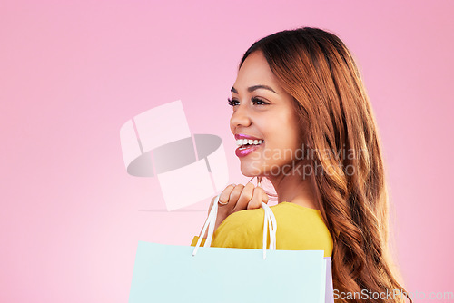 Image of Woman, shopping bag and thinking of space in studio with a customer happy about promotion or discount. Female model or shopper on a pink background for fashion, sale and gift or surprise with a smile