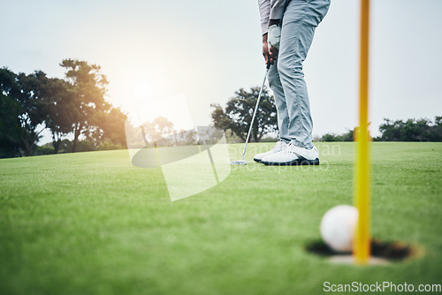 Image of Ground, golf hole and man with golfing club on course for game, practice and training for competition. Professional golfer, sports and male athlete hit ball on grass for winning, score or tee stroke