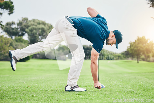 Image of Man, golf ball and tee on grass to ready for game, sport or international competition with focus outdoor. Professional golfer, start and preparation for contest on field, lawn and course in summer