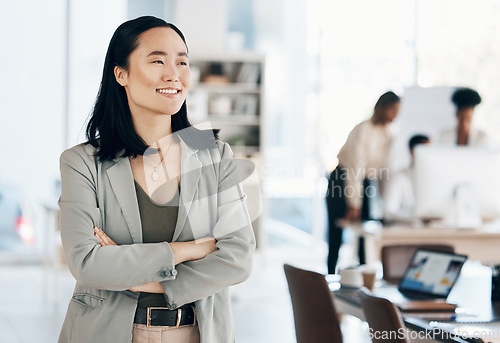 Image of Asian, business woman with arms crossed and happy, thinking with leadership and professional mindset in workplace. Career, success and corporate female in Japanese office, happiness and confidence