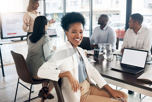 Image of Portrait, meeting and a business black woman in the boardroom with her team for a strategy presentation on laptop mockup screen. Workshop, training and collaboration with a female sitting at a table