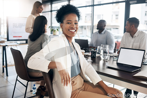 Image of Portrait, meeting and a black woman in a business boardroom with her team for a strategy presentation on laptop mockup screen. Workshop, training and collaboration with a female sitting at a table
