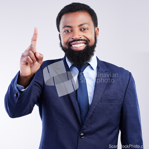 Image of Portrait, volunteer and a business black man in studio on a gray background with his finger raised. Question, management and one with a handsome african american male executive in a corporate suit