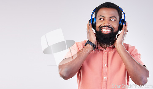 Image of Black man, studio mockup space and headphones for music to relax, listen and streaming by background. Happy african model, audio and sound for peace, mindfulness and online podcast with smile on face