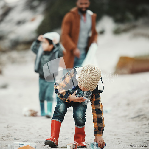 Image of Beach clean, plastic and pollution with a child cleaning the environment for dirt or bottle on sand. Male kid and family walking as volunteer for sustainability, community service and global warming