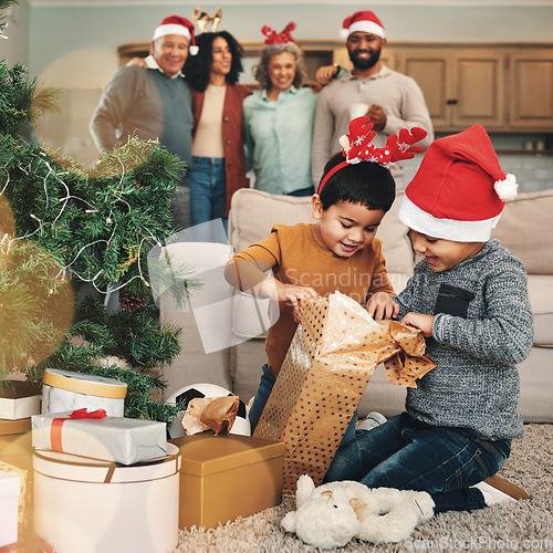 Image of Christmas, excited and children opening gifts, looking at presents and boxes together. Smile, festive and kids ready to open a gift, or present under the tree for celebration of a holiday at home
