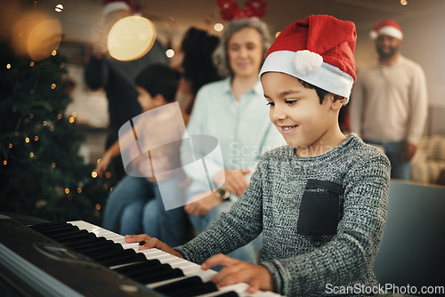 Image of Boy, music keyboard and christmas in family home with smile, playing and creative skill with grandmother. Male kid, young musician and grandparents by piano for holiday cheer, bond and pride in house