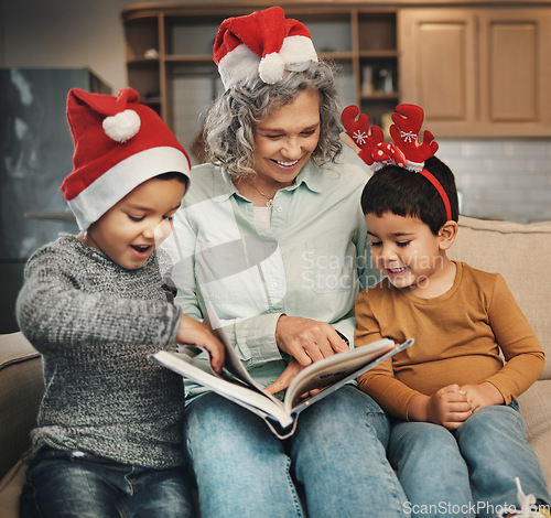 Image of Christmas, photo album or children with a happy grandmother and kids looking at photographs during festive season. Family, love or celebration with a woman and grandchildren holding a picture book