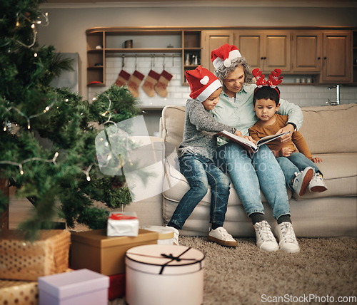 Image of Christmas, photo album or children with a senior grandmother and kids looking at photographs during festive season. Family, love or celebration with a woman and grandchildren holding a picture book