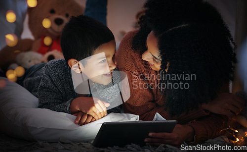 Image of Mother, son and tablet on bed in night with smile, streaming movies and bond with happiness, love or care. Woman, boy child and mobile touch screen in bedroom for story, video or happy in family home