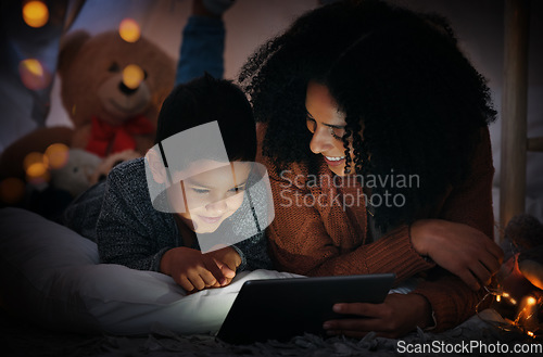 Image of Movie, dark and a mother and child with a tablet before bedtime for a show, video or meme. Happy, streaming and a mom and boy kid watching a film, cartoon or series online with technology at night