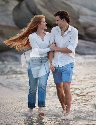 Image of Love, holding hands and happy with couple at beach for romance, relax and vacation trip. Travel, sweet and cute relationship with man and woman walking on date for summer break, trust and bonding