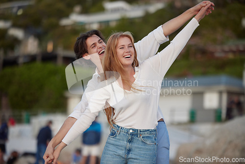 Image of Flying, happy and laughing couple at the beach for a date, honeymoon and bonding in Bali. Smile, comic and playful man and woman with care, love and affection at the sea for happiness together