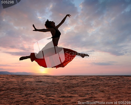 Image of Jumping woman at sunset