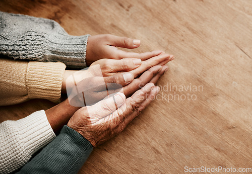 Image of People, hands together and generations in support above on mockup for unity, compassion or trust on wooden table. Group holding hand in collaboration, love or care for community, teamwork or union