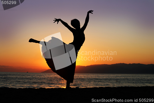 Image of Dancing woman at sunset