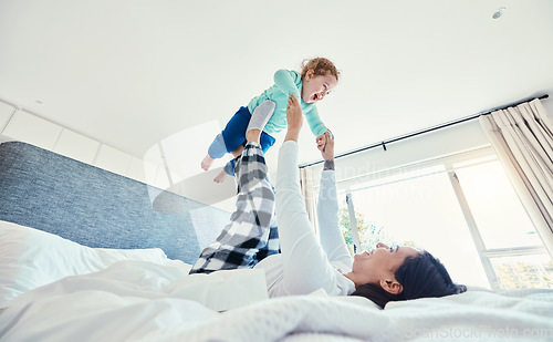 Image of Bed, morning and a mother playing with her daughter in a bedroom of their home together for bonding. Family, kids or love with a woman and girl child having fun together after waking up on a weekend
