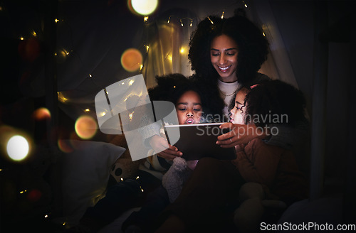 Image of Mother, kids and tablet in home tent, streaming movie or video, having fun and bonding. Mixed race family, care and happy mama, children or girls with touchscreen tech for internet browsing at night.