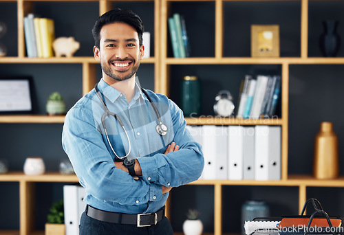Image of Portrait, Asian man and doctor with healthcare, arms crossed and success in workplace. Face, Japanese male employee and happy medical professional with leadership, management and happiness in office