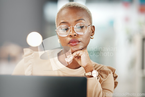 Image of Office, laptop and black woman with glasses, thinking or reading email, online research or report. Computer, concentration and African journalist proofreading article for digital news website or blog