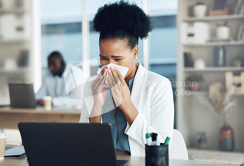 Image of Work, healthcare and black woman at desk blowing nose with tissue paper from flu, cold or hay fever. Sick, exhausted office employee with allergy and sinus problem, health risk from illness at laptop