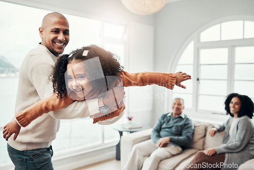 Image of Family, flying and a father playing with his daughter in the living room of their home together during a visit. Children, energy and a man having fun with his girl while bonding in a house for love