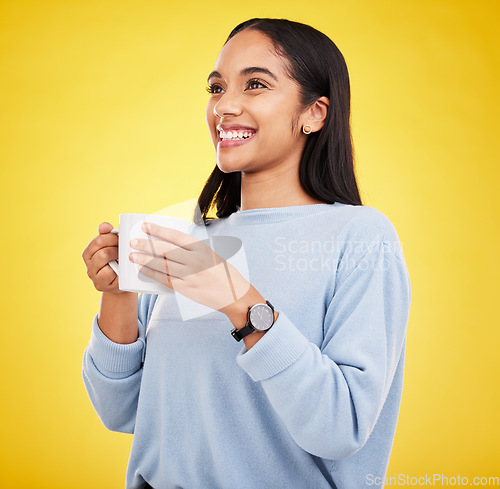 Image of Morning, coffee mug and happy woman in a studio with a smile from espresso. Isolated, yellow background and smile of a young female with happiness and joy ready to start the day with confidence